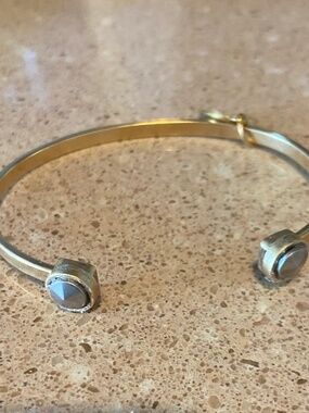 Julio Gold Tone bangle bracelet with silver tone end accents